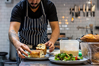 A chef carefully plating a dish.